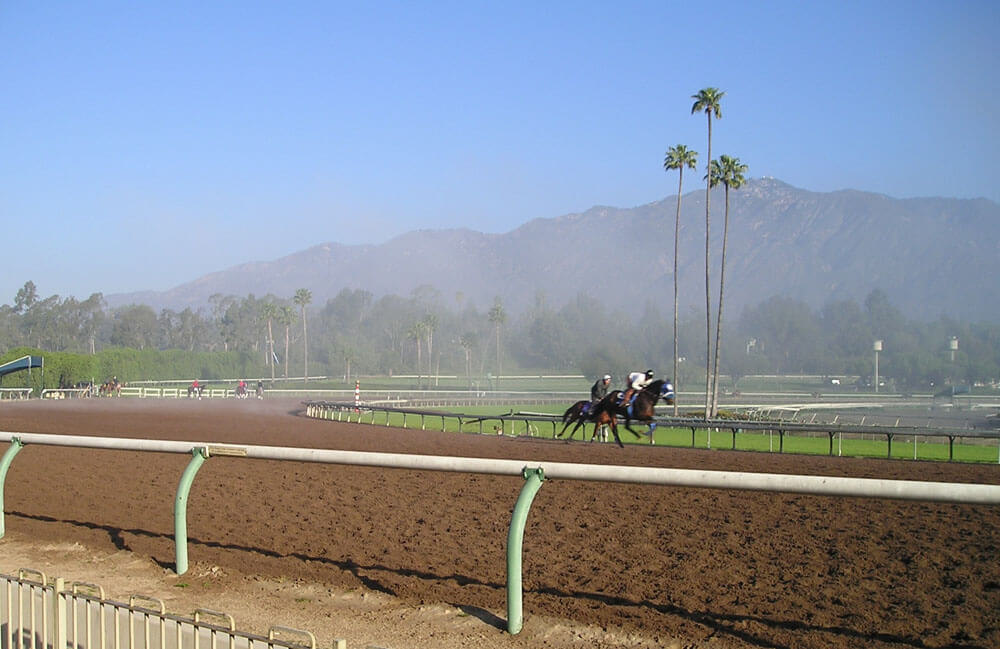 Santa Anita Park track conditions and racing surface with San Gabriel Mountains backdrop